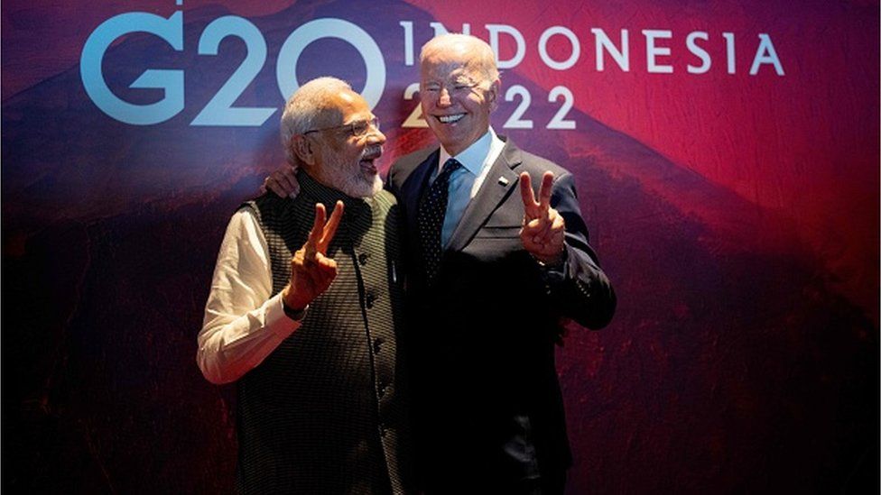 President Joe Biden (R) gestures with India's Prime Minister Narendra Modi as the two leaders met in a hallway as Biden was going to a European Commission on the Partnership for Global Infrastructure and Investment on the sidelines of the G20 Summit in Nusa Dua, on the Indonesian island of Bali, on November 15, 2022