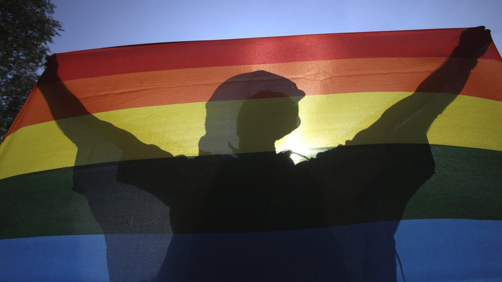 A Hungarian participant holds a rainbow flag during a Pride parade in Budapest