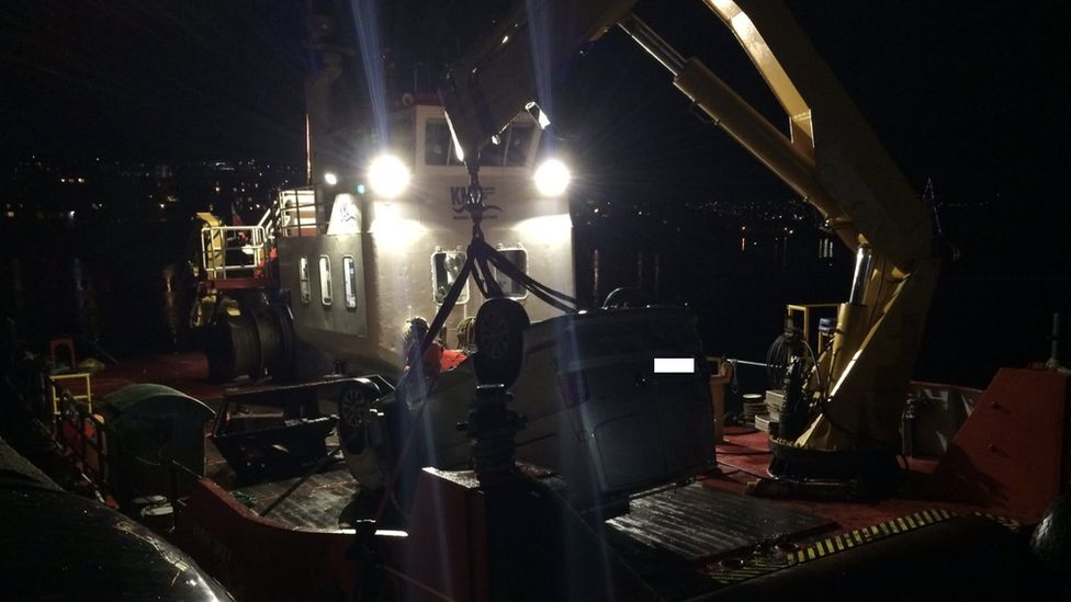 Van recovered by crane on salvage boat
