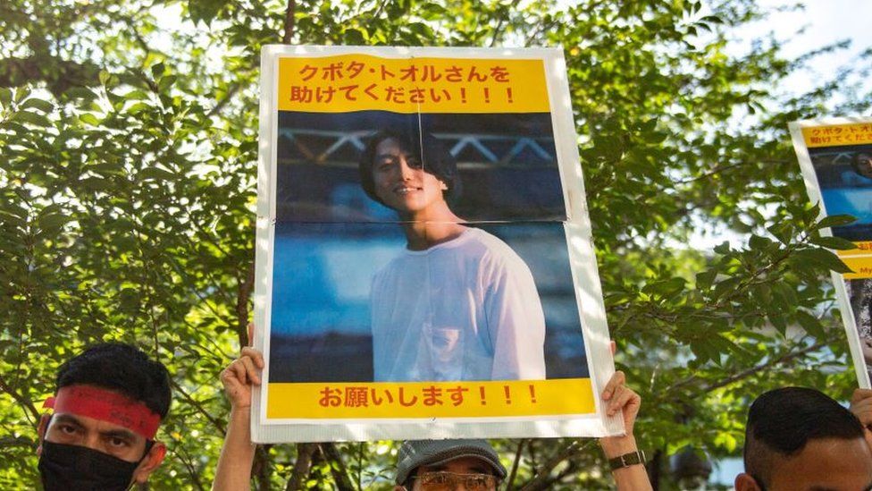 A group of activists hold placards of Japanese citizen Toru Kubota, who is detained in Myanmar, during a rally in front of the Ministry of Foreign Affairs in Tokyo on July 31, 2022.