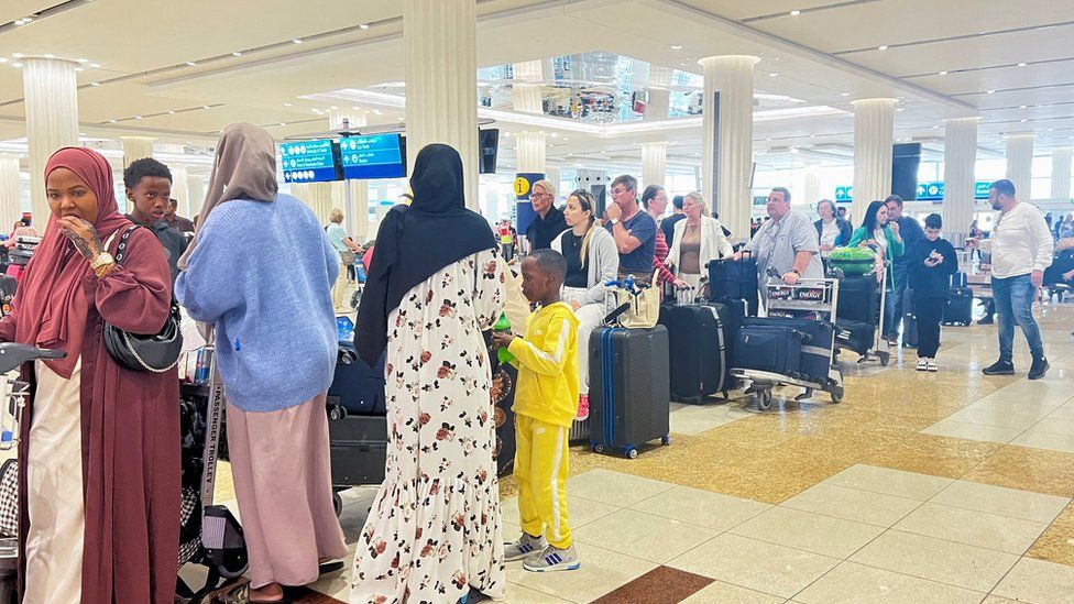 People queue at the check-in counter after a rainstorm hits Dubai, causing delays at the Dubai International Airport, in Dubai, United Arab Emirates, April 17, 2024. R