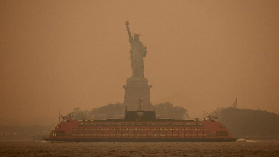 Orange haze blankets North America cities as Quebec wildfire smoke spreads  - BBC News