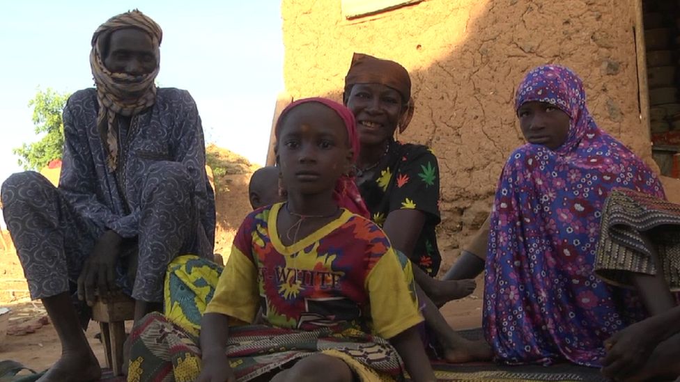 Hadizatou Mani sitting with three members of her family