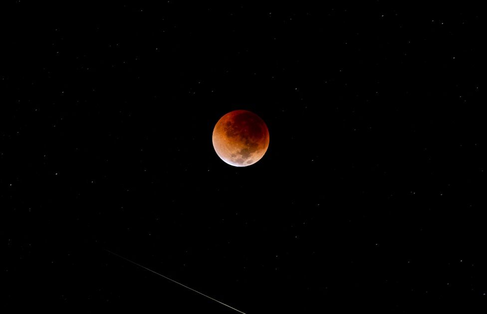 The supermoon lunar eclipse as seen from the Zambezi River in Zimbabwe. In this year"s only full lunar eclipse, the moon will turn a deep coppery red as it drifts into the shadow of the Earth. The Earth"s atmosphere then bends light from the sun and bathes the moon in a red hue. Issue date: Monday May 16, 2022