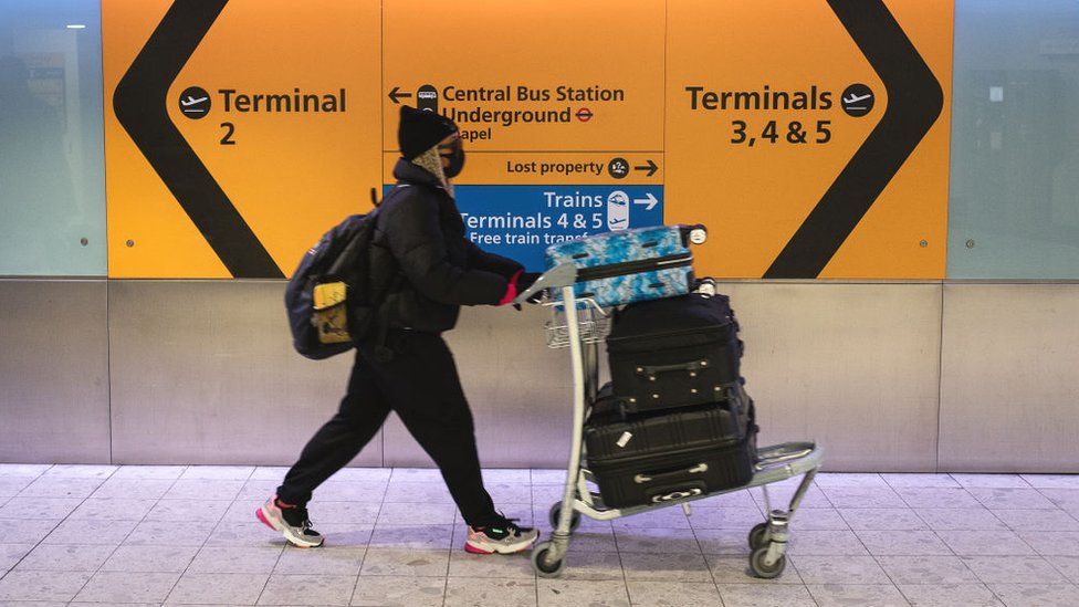 Passenger with mask at Heathrow Airport departures