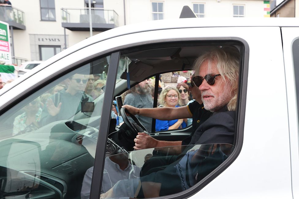 Bob Geldof rides in a taxi as part of the funeral cortege for Sinead O'Connor as the procession passes through her former hometown of Bray, Co Wicklow on 8 August 2023