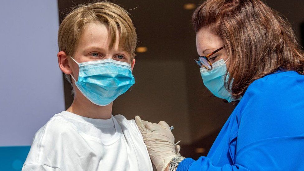 A 13-year-old boy is vaccinated in the US in May