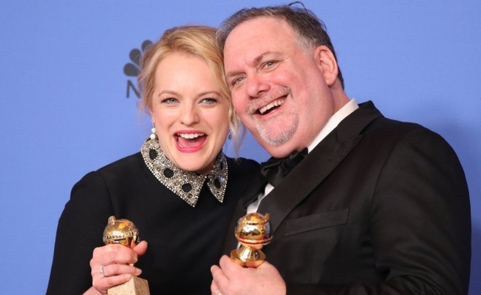 Actress Elisabeth Moss and producer Bruce Miller pose with the awards they won for The Handmaid's Tale
