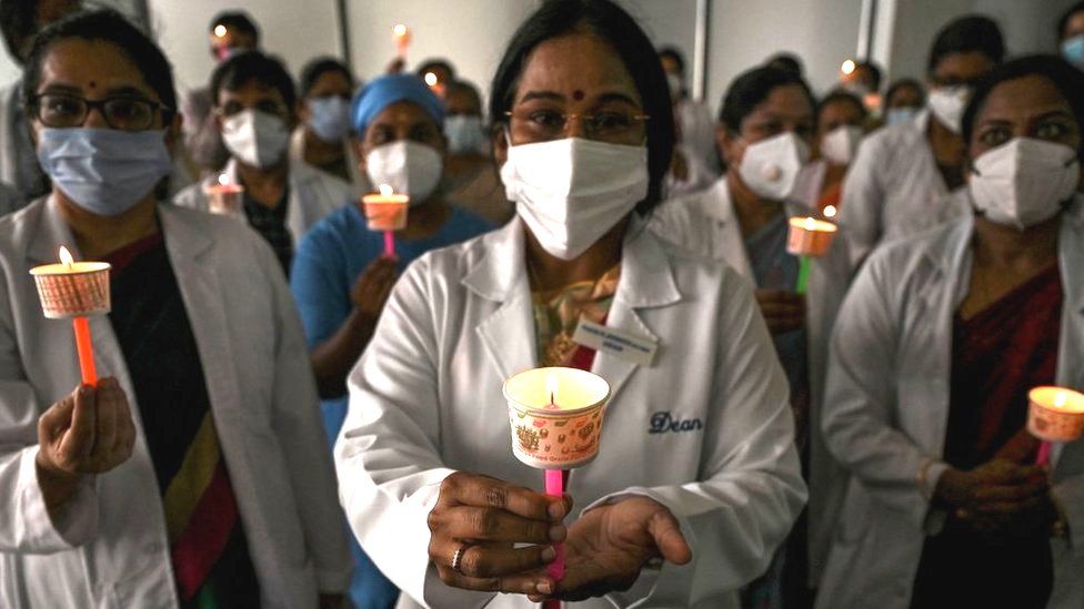 Doctors observe a candlelight vigil in tribute to doctors who lost their lives during the ongoing Covid-19 coronavirus pandemic on the occasion of National Doctors' Day, in Chennai on July 1,