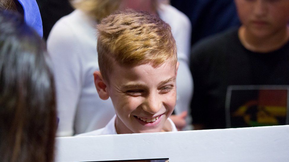 Emad Mishko Tammo, twelve-year-old Yazidi boy,smiles as he is reunited with his family