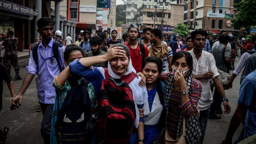 A woman cries after clashes with police during a student protest in Dhaka on August 5, 2018