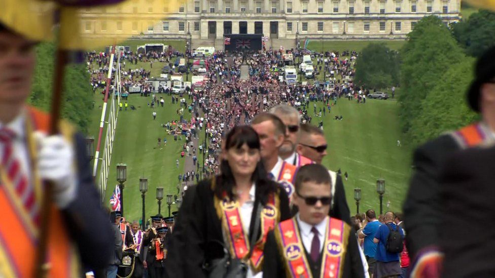 The parade leaves the grounds of Stormont