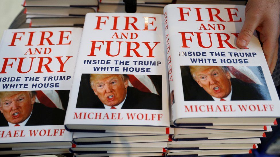 A shop worker arranges copies of Michael Wolff"s book "Fire And Fury" as they go on sale inside a branch of the Waterstones book store in Liverpool, Britain