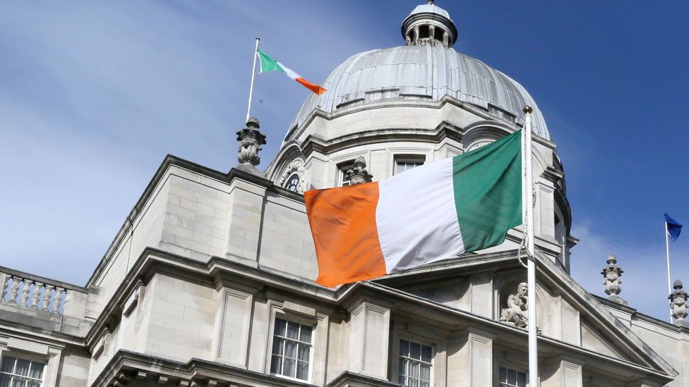 An Irish national flag flies outside the Government Buildings in Dublin, Ireland