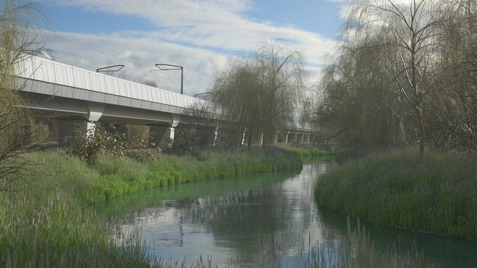Large concrete viaduct crossing through grass near river