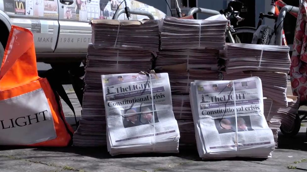 Bundles of the Light newspaper with the headline "Constitutional crisis" piled up in Totnes