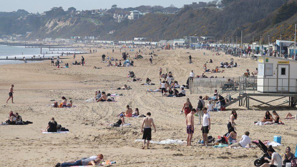 People enjoy the warm weather on Bournemouth beach in Dorset