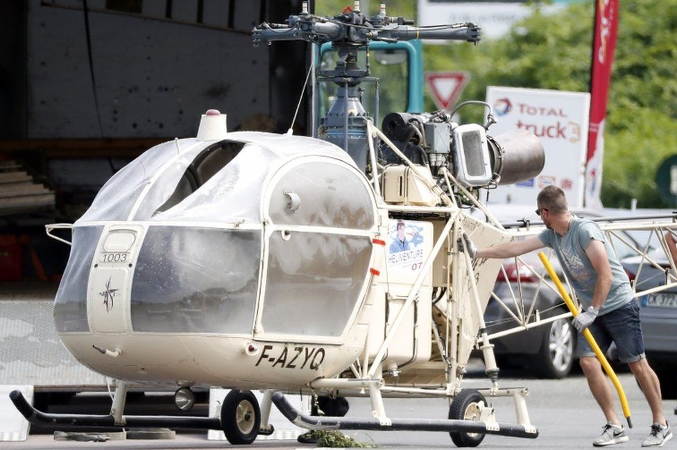 Investigators transport an Alouette II helicopter allegedly abandoned by French prisoner Redoine Faid and his suspected accomplices after his escape