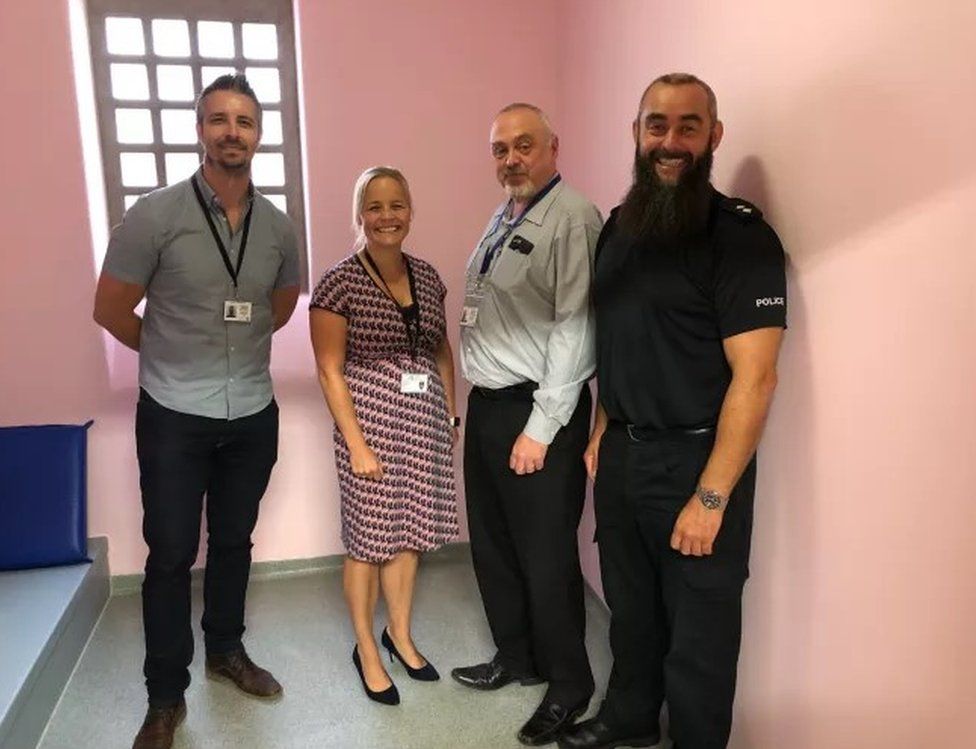 Pink jail cell with (l-r) Sgt Dave Williams, Supt Katy Barrow-Grint, former Ch Insp Dave Cherrington, Insp Dave Entwistle