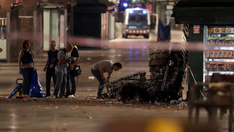 Police officers examining debris