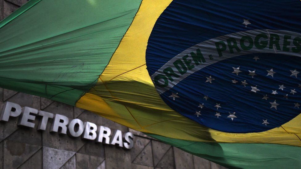 The Brazilian national flag flutters at the front of the headquarters of the Brazilian state oil giant Petrobras, in Rio de Janeiro, Brazil, on March 13, 2015