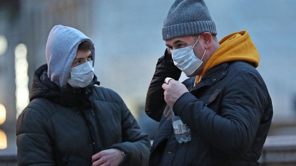 Men wearing face masks in central London