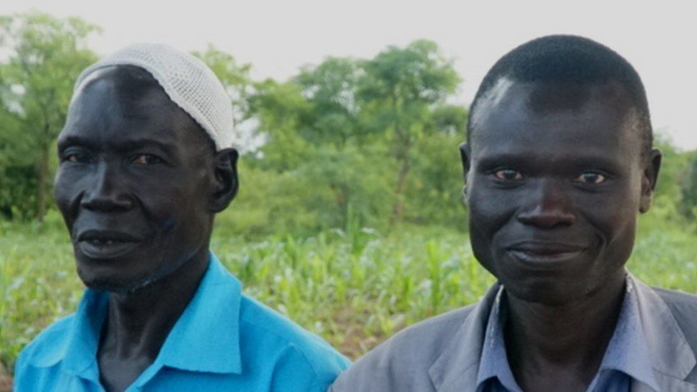 Issa Agub (L) and the refugee he gave land to pictured in Uganda