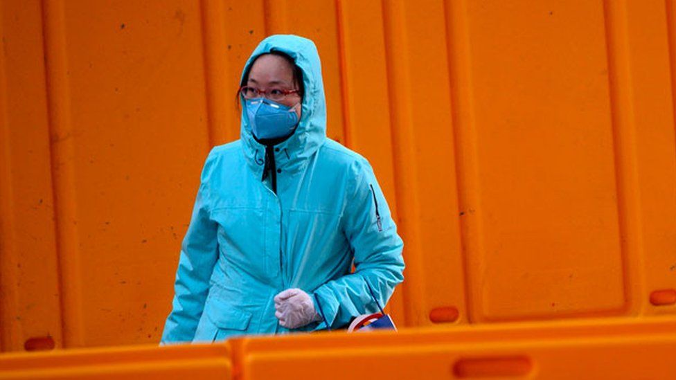 A woman in China wearing a facemask