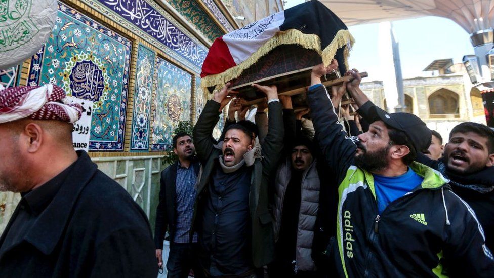 People attend the funeral ceremony of 17 Iran-affiliated militants in Baghdad, Iraq