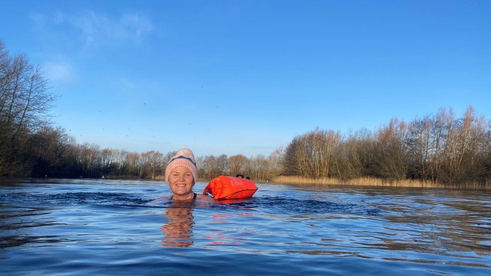 Dinah swimming, with a floatation device