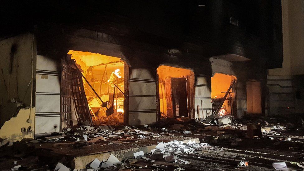 This picture taken early on July 2, 2022 shows a fire inside the building used by Libya's Tobruk-based parliament building in the country's east, lit up by protesters who broke inside while demonstrating against deteriorating living conditions and political deadlock.