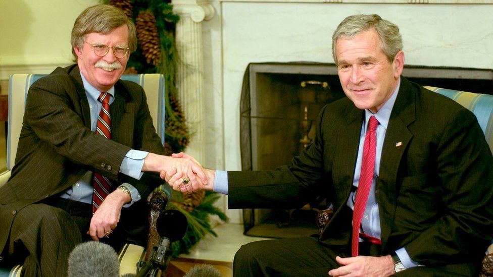 US President George W Bush (R) and Ambassador to the UN John Bolton (L) meet in the Oval Office in December 2006