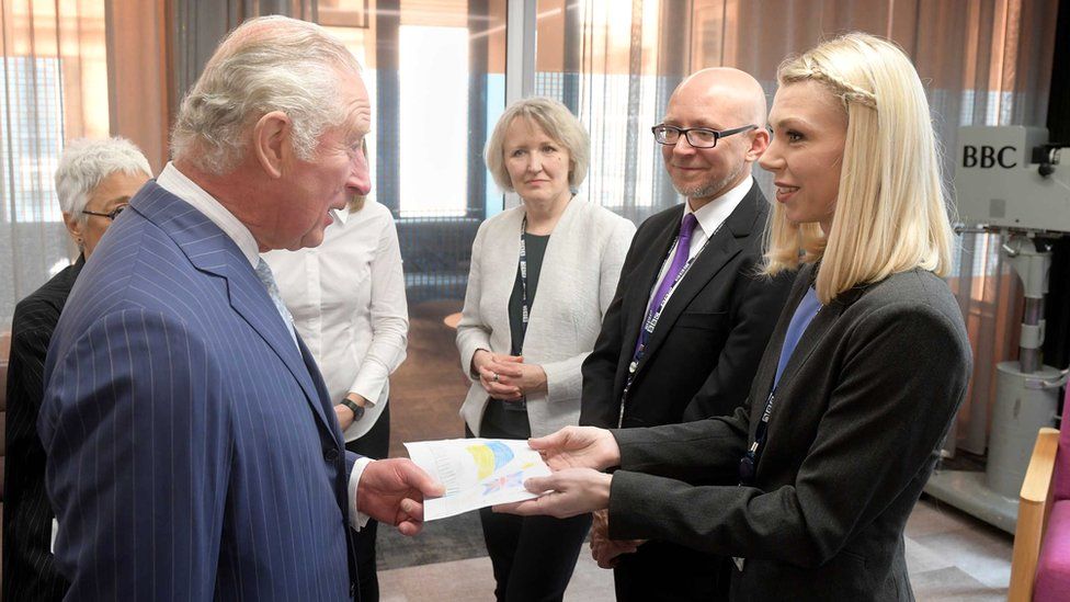 Prince Charles accepting the drawing from journalist Olga Malchevska