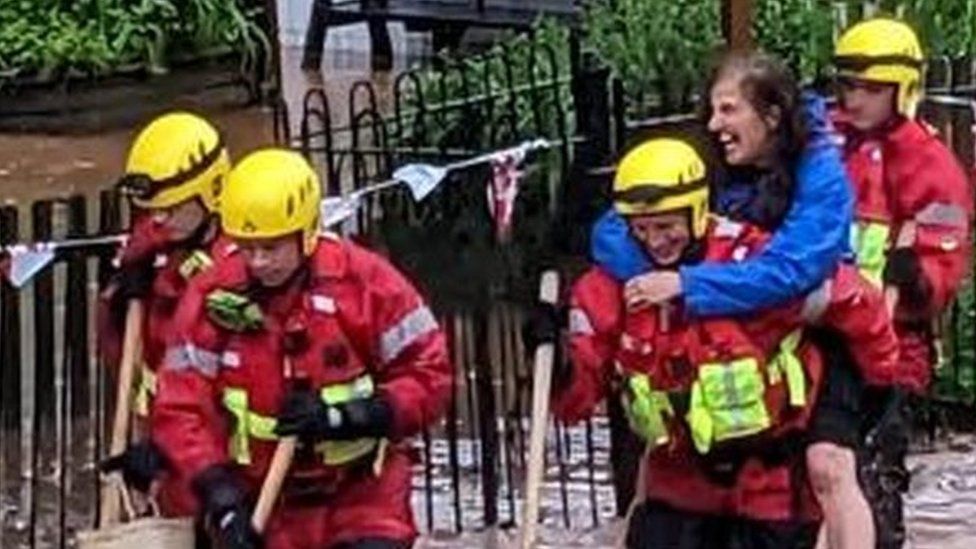 Teacher Naomi Garrick being rescued by firefighters