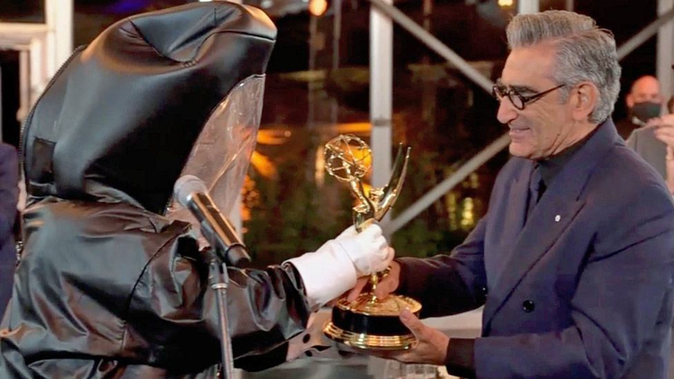 Eugene Levy received his best comedy actor award from a presenter in a hazmat suit