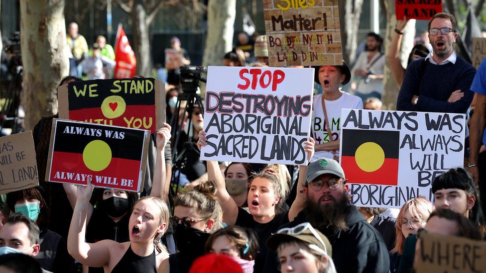 Protesters are seen during a rally outside the Rio Tinto office in Perth