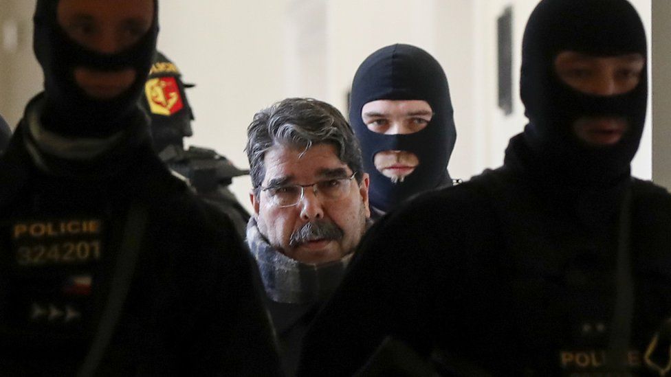 Syrian Kurdish leader Saleh Muslim (C) is escorted by Czech police for his trial at the municipal court on February 27, 2018 in Prague.
