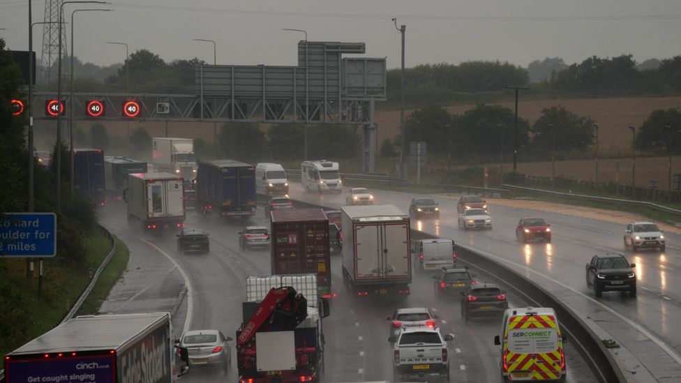Slow traffic in heavy rain on the M62 near Brighouse in West Yorkshire