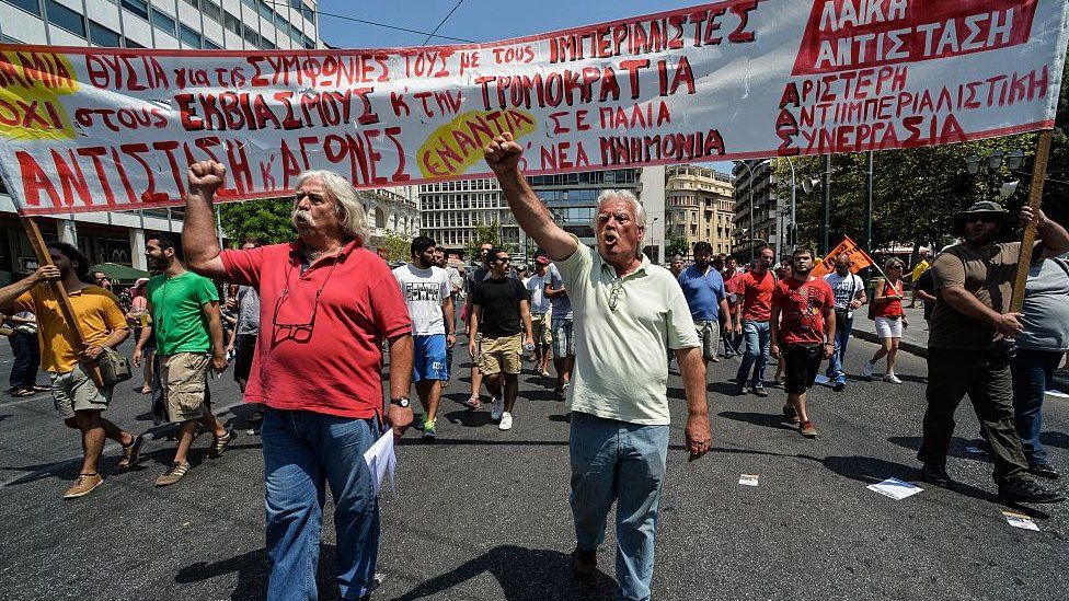 Protesters chant slogans during a protest march in central Athens on July 15, 2015 marking a 24-hour public sector worker and pharmacists strike against the new package of austerity measures