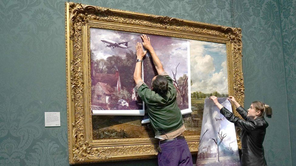 Protesters from Just Stop Oil climate protest group, cover John Constable's The Hay Wain with their own picture at the National Gallery, Londo