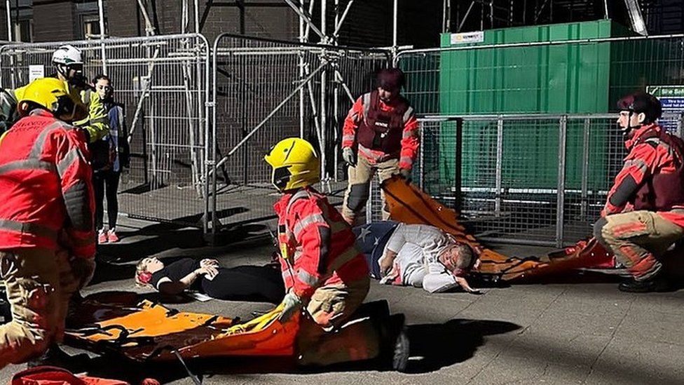 Emergency services attending to casualty in training exercise