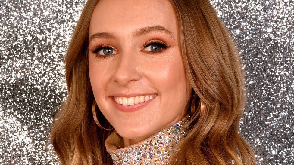 Rose Ayling-Ellis smiling at the camera wearing a sparkly dress