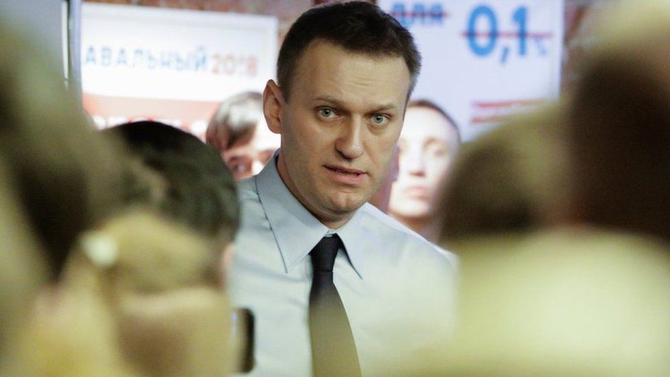 Russian opposition leader Alexei Navalny speaks with his supporters at the opening of his campaign office in St. Petersburg, Russia