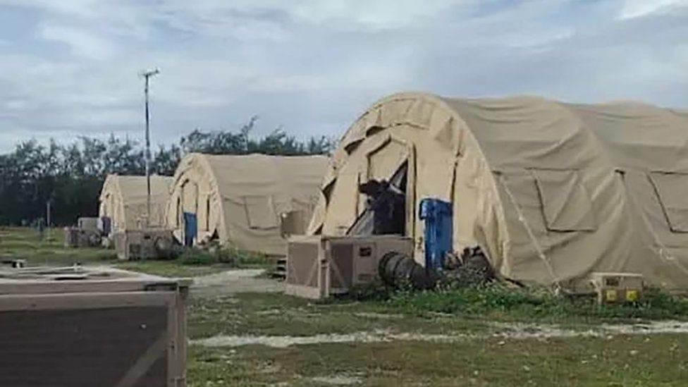 A low-resolution photo showing three large khaki tents used to house migrants on Diego Garcia