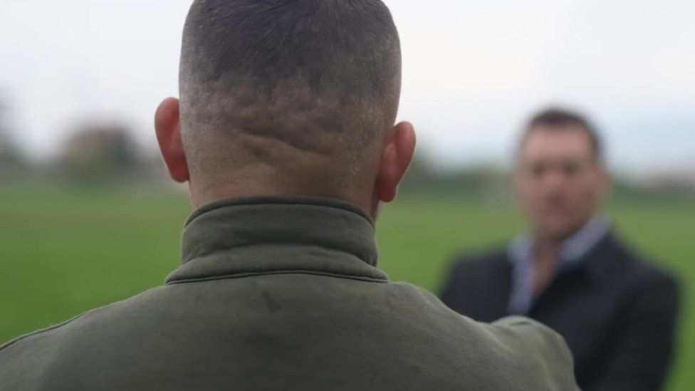 The back of Artan's head as he speaks to BBC reporter, Joe Inwood.