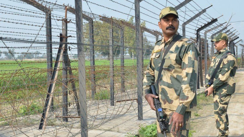 Indian Border Security Force personnel walk along a fence at the India Pakistan border on the outskirts of Amritsar on February 27, 2019.