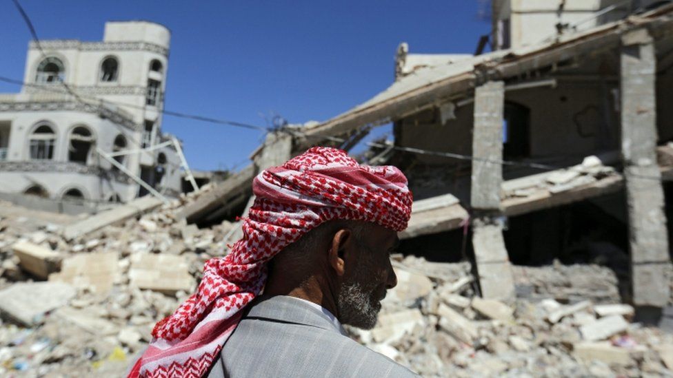 A Yemeni inspects the damage in a building which was targeted by Saudi-led airstrikes at a neighbourhood in Sana'a, 21 March 2016