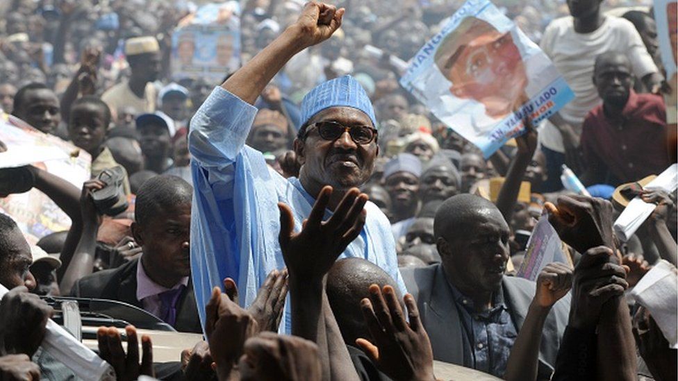 Muhammadu Buhari raises his hand to salute the crowd shortly on arrival to flag off his presidential campaign rally in Kaduna Wednesday, on March 2, 2011.