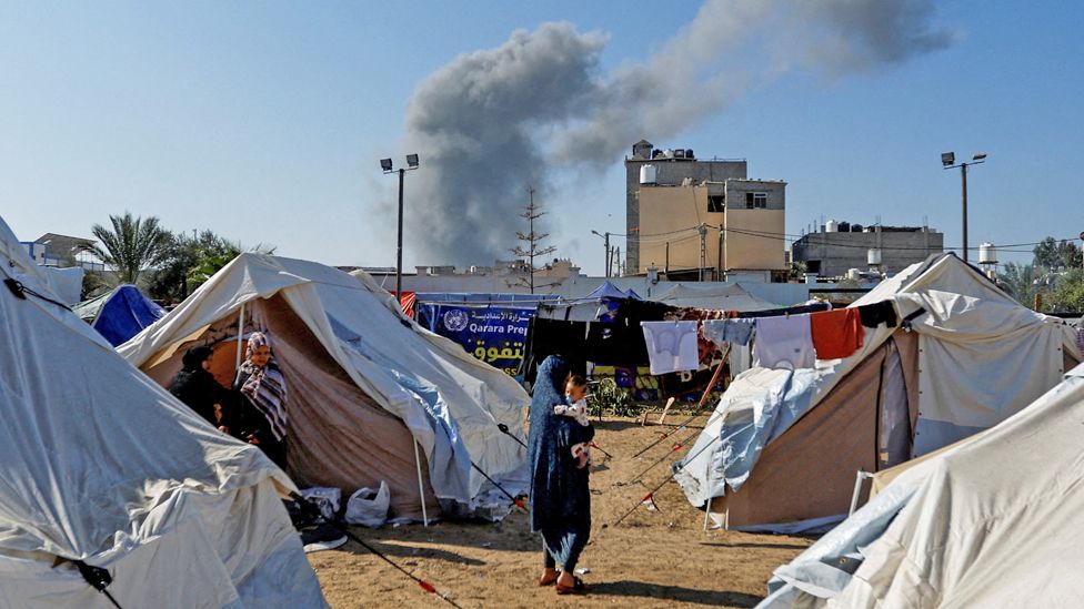 Smoke rises after an Israeli strike near a tented camp for displaced Palestinians in Khan Younis, in the southern Gaza Strip (26 October 2023)