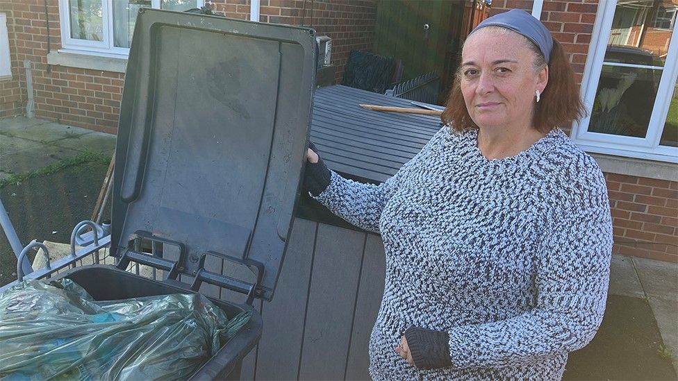 Jacqueline Barnes with an overflowing bin